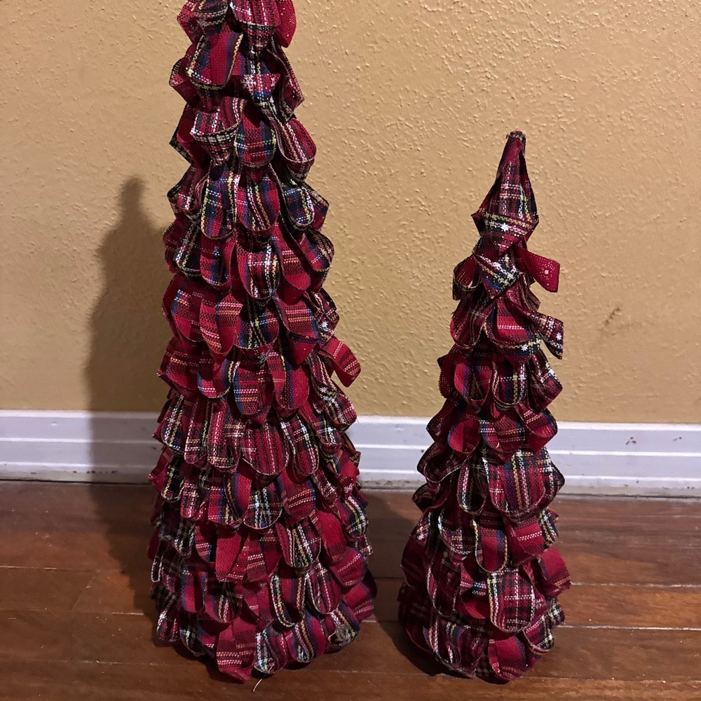 Christmas tree decorated with red and black plaid fabric or ribbon.